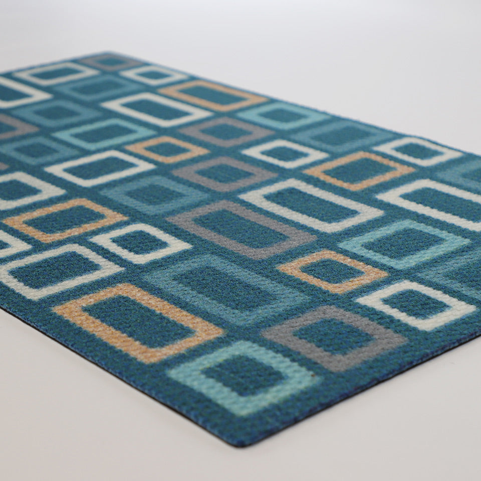 Multi shades of aqua and tan in squares on a dark aqua doormat
