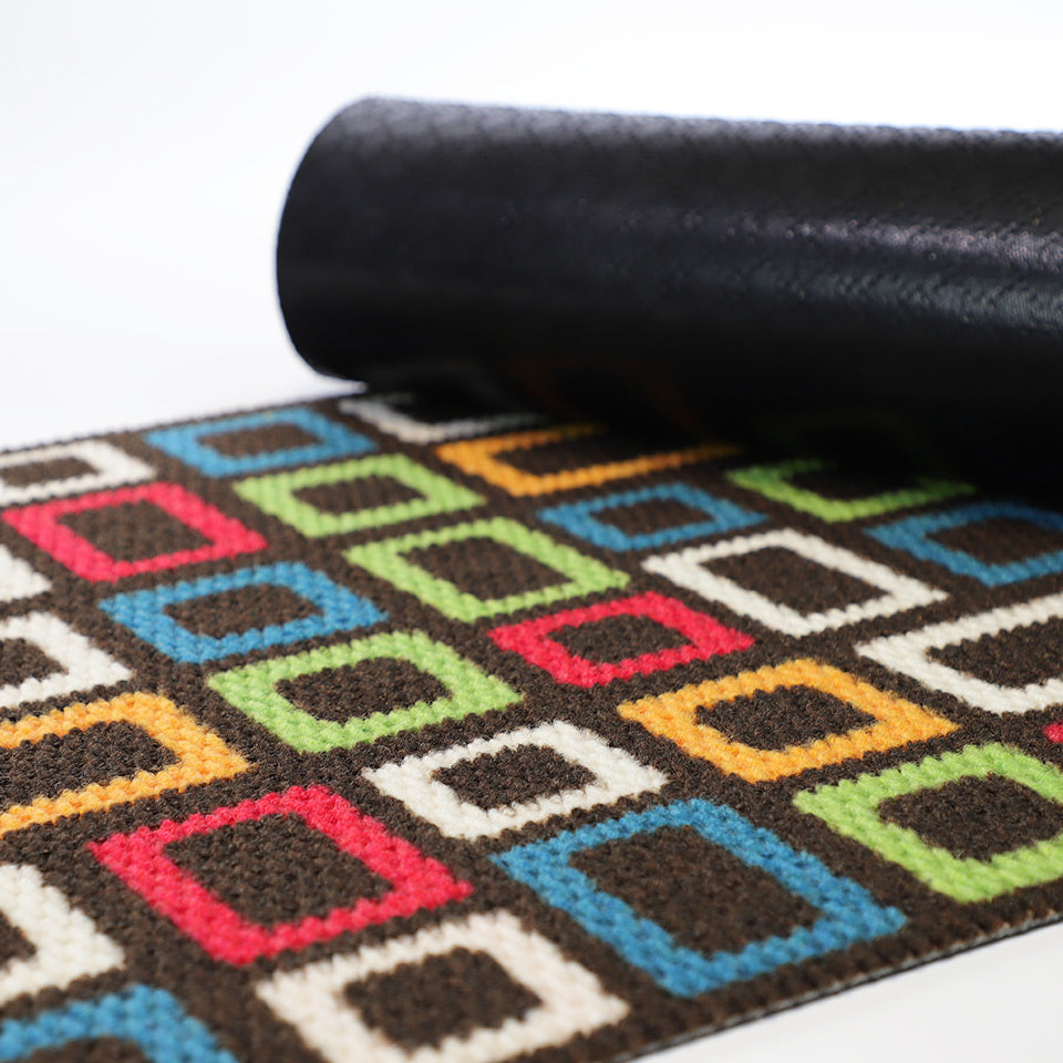 Rubber back of doormat shown on top of retro inspired geometric colorful doormat
