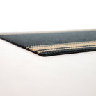 Close up low profile shot of black and tan striped doormat