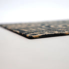 Close up of low profile view of Medallions doormat in coir and black
