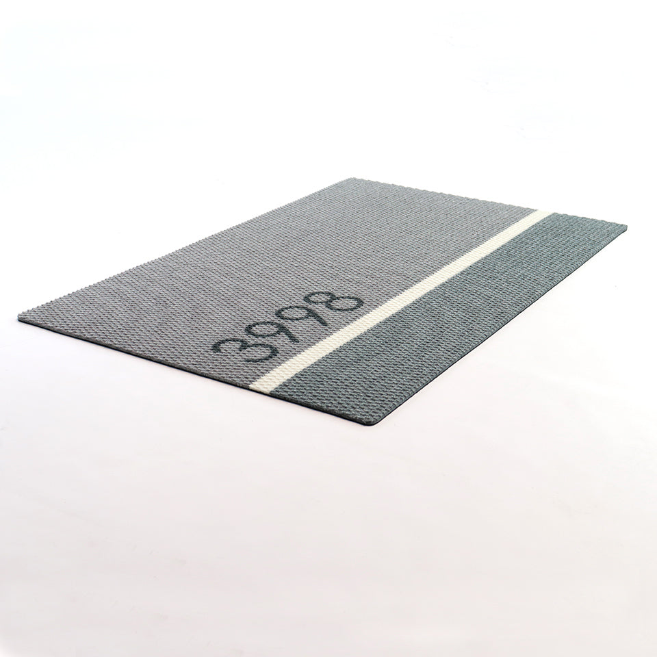 Angle shot of Modern Main personalized doormat with house number