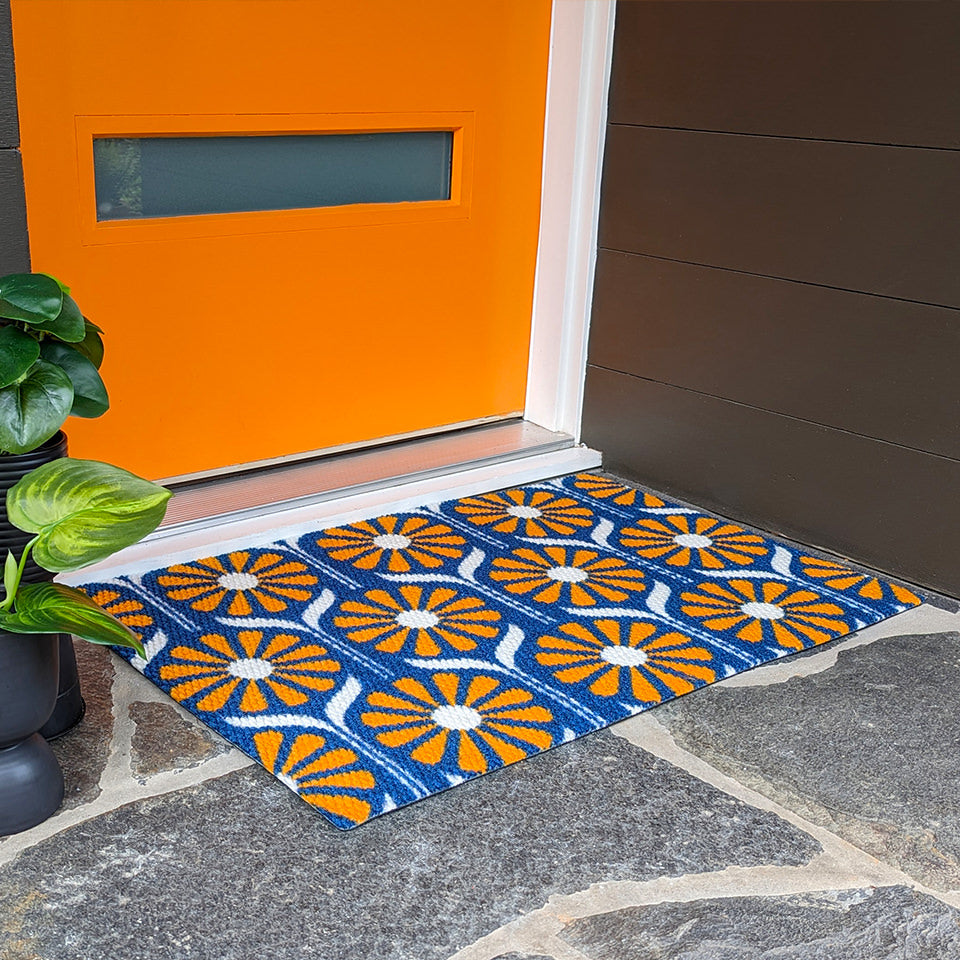 Mid century modern inspired Retro Daisies doormat in orange and blue.  A nostalgic nod to the MCM style of home decor