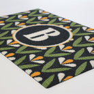 Angled shot of Spring Blooms monogrammed doormat - personalized with your initial for a customized front porch or entryway. Part of our Mid Century Modern collection of doormats.