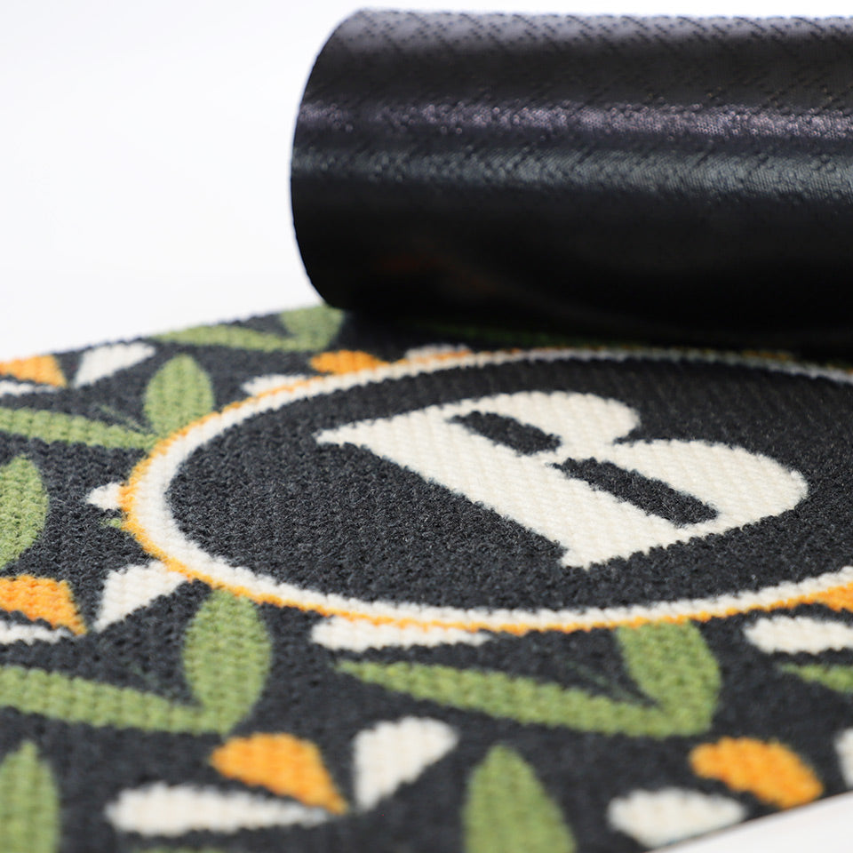 Rubber backing shown on Spring Blooms floral monogrammed doormat.  Rubber backing on our doormats help prevent slipping and sliding
