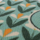 Close up of Spring Blooms floral doormat in aqua green and yellow.  Monogrammed doormats create a customized look personalized for your door!