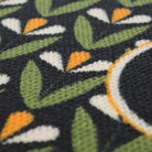 Close up of Spring Blooms monogrammed personalized doormat in green/yellow on black