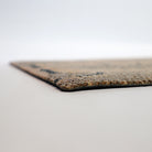 Low profile view of our Tailfeathers doormat shown in coir and black.  Non shedding top with rubber backing to help prevent slips