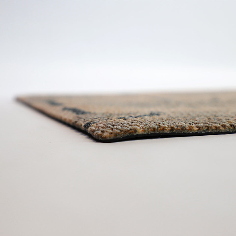 Low profile view of our Tailfeathers doormat shown in coir and black.  Non shedding top with rubber backing to help prevent slips