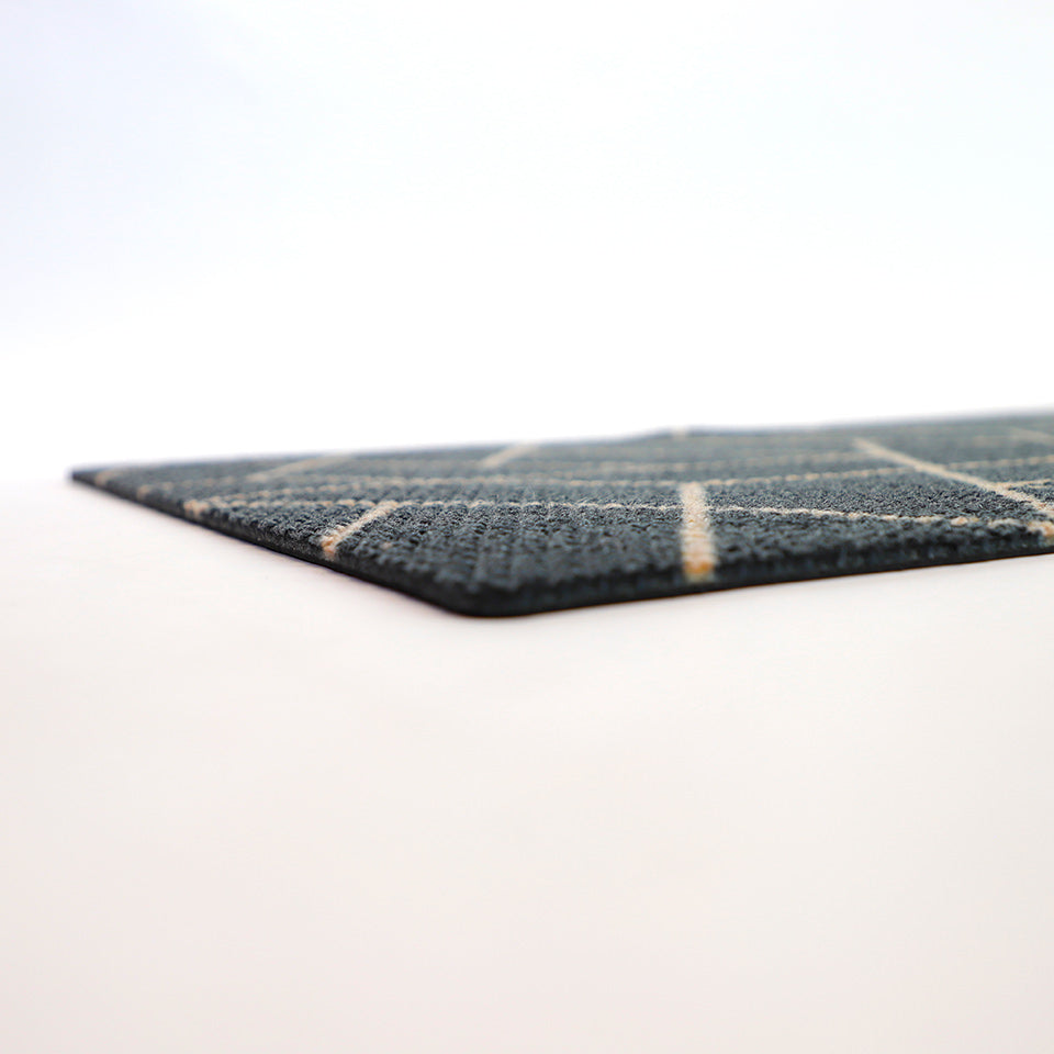 Low profile shot of our Neighburly doormat in triangulation pattern. A geometric black and coir patterned doormat.