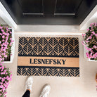 botanical personalized mat with last name in front of front door