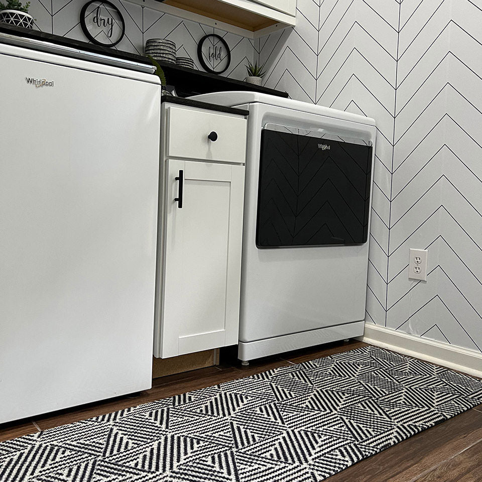 double door size escher doormat in black and white in front of washer and dryer in laundry room