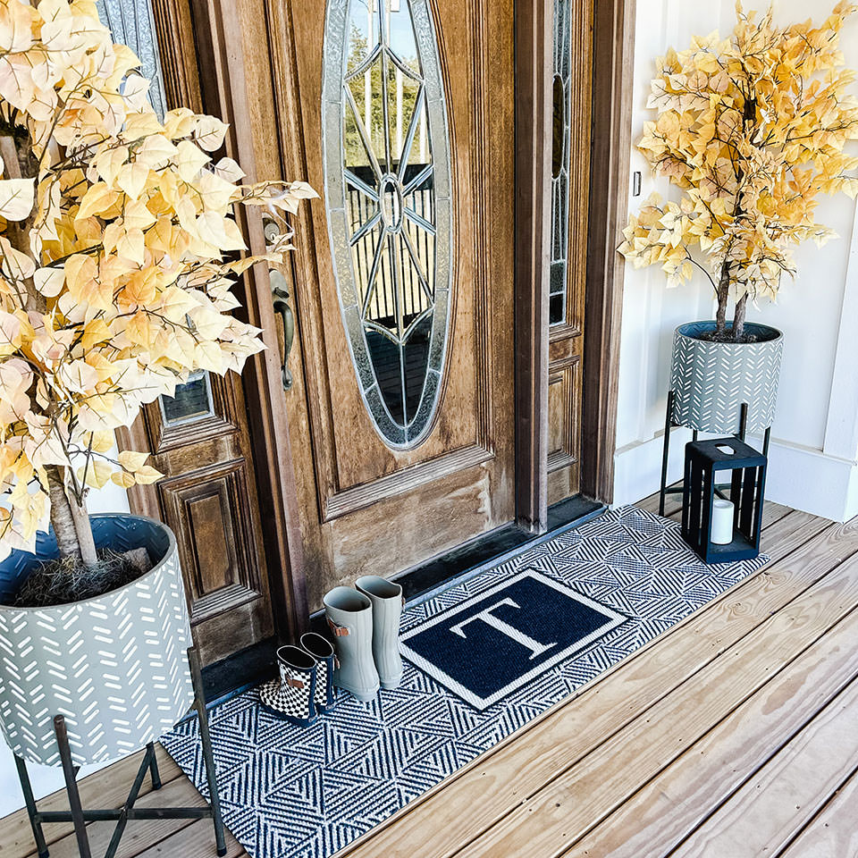 black and white double door monogrammed escher doormat outside front door with sidelights