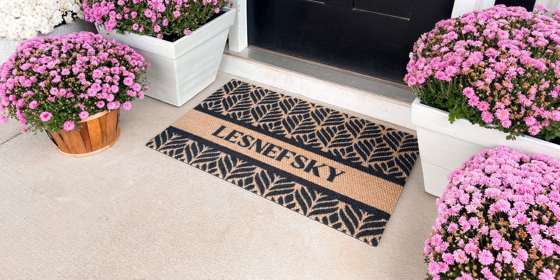 Neighuburly Botanical personalized with a last name on a single sized, indoor doormat with a floral design.