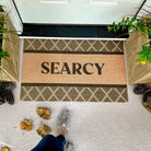 Argyle personalized mat with last name "Searcy" in front door entryway.