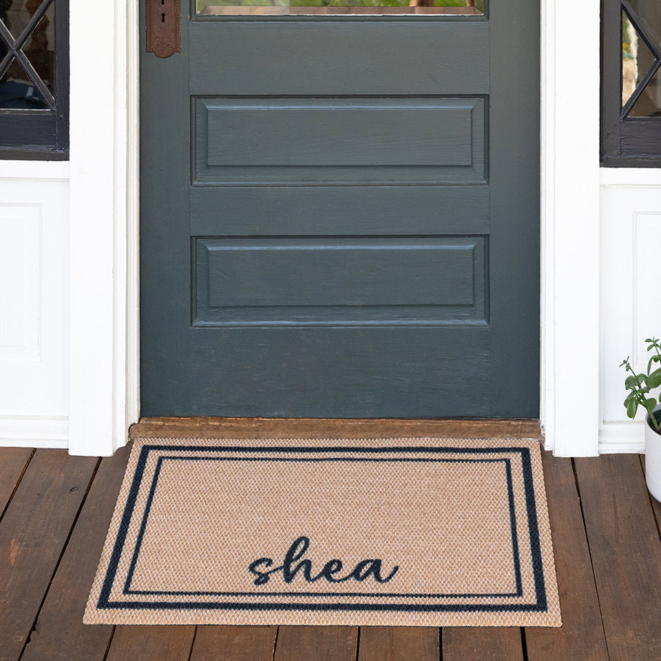 Low-profile Around The Block personalized with Shea and laid in front of a shut front single door.