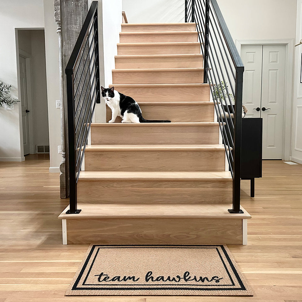 Neighburly's Around The Block with a unique personalization of Team Hawkins laid out at the bottom of a staircase for floor protection.