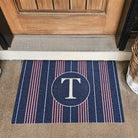 Single Door Basic Stripe Monogrammed doormat with the letter T in the center circle with stripes all beside it.