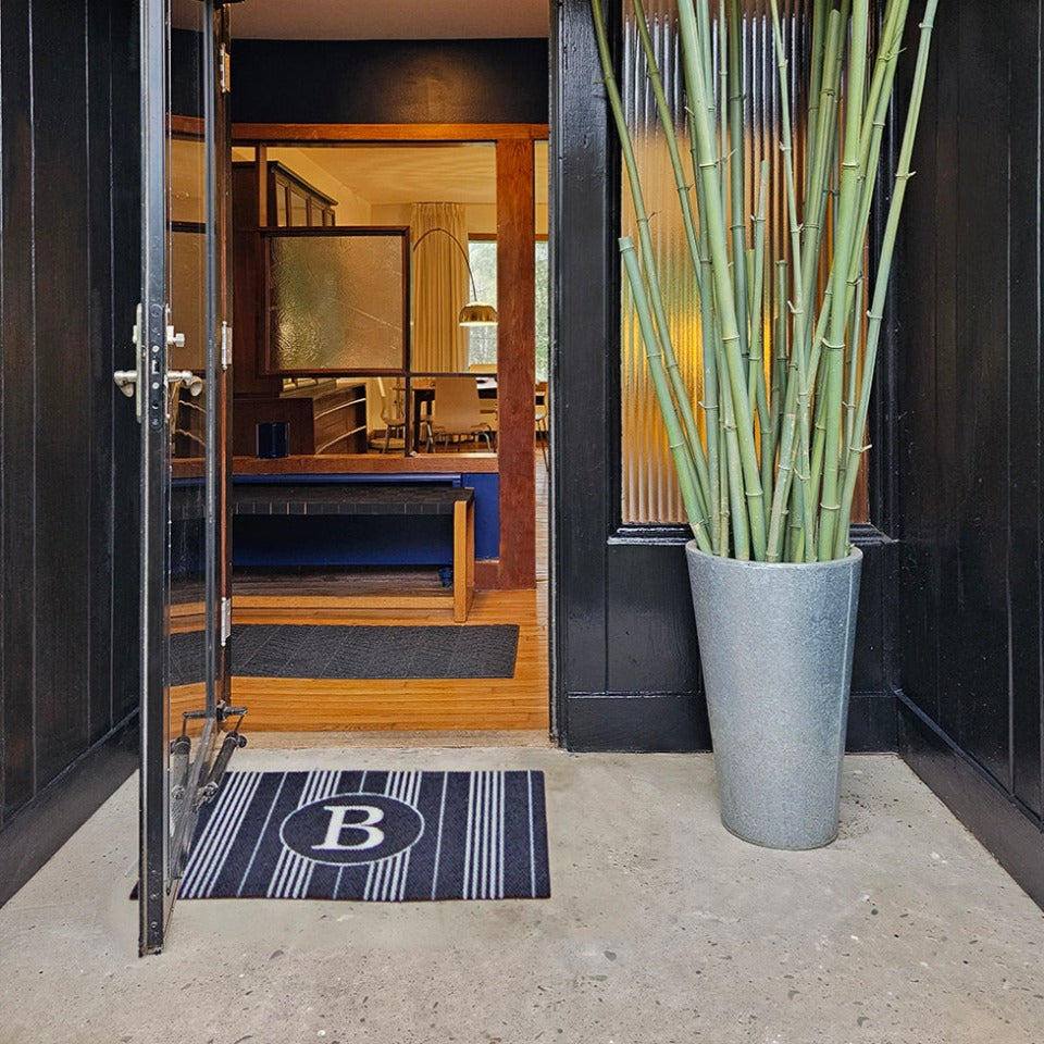 Beautiful modern retro entryway featuring a black and white monogrammed Neighburly doormat.