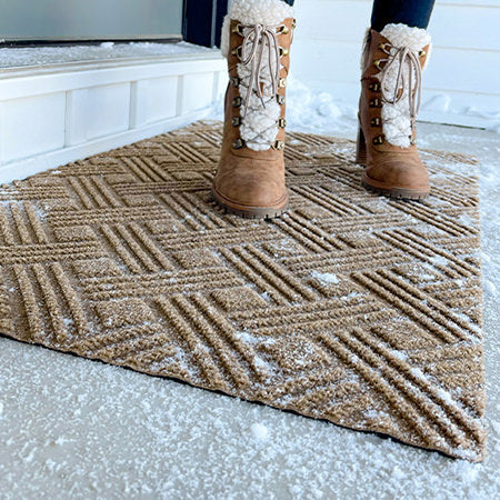 Matterly Classic Thatch doormat in wheat color is placed at front door in winter conditions to help wipe boots of snow, ice, and rain. These durable door mats are made in America.