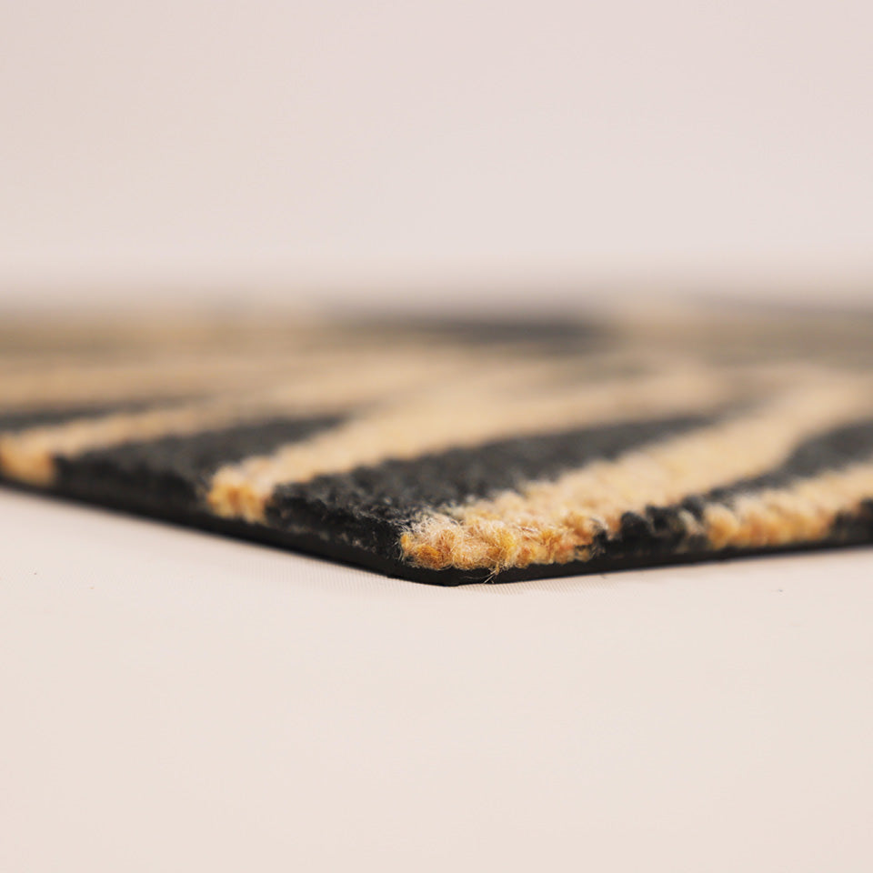 Up-close corner image of Dahlia’s low profile, non shedding surface, and rubber backing