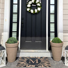 Low-profile Dahlia entrance mat monogrammed with the initial M at the entrance of a home for protection.