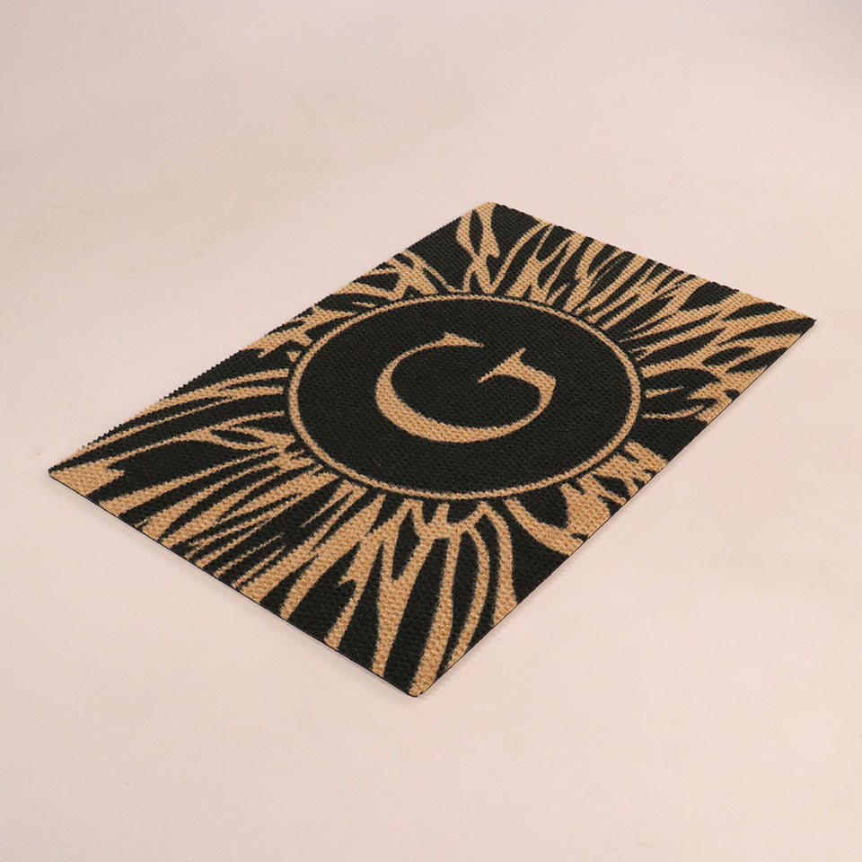 Dahlia single door mat angled overhead monogrammed G abstract line around it, black and coir