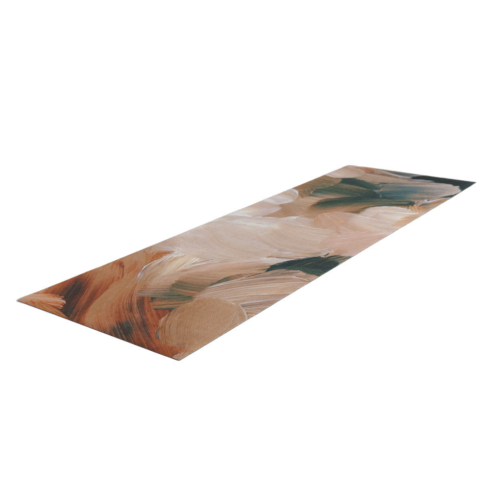Indoor runner sized low profle washable mat shown printed abstract painting of rust, cream colors, and dark teal