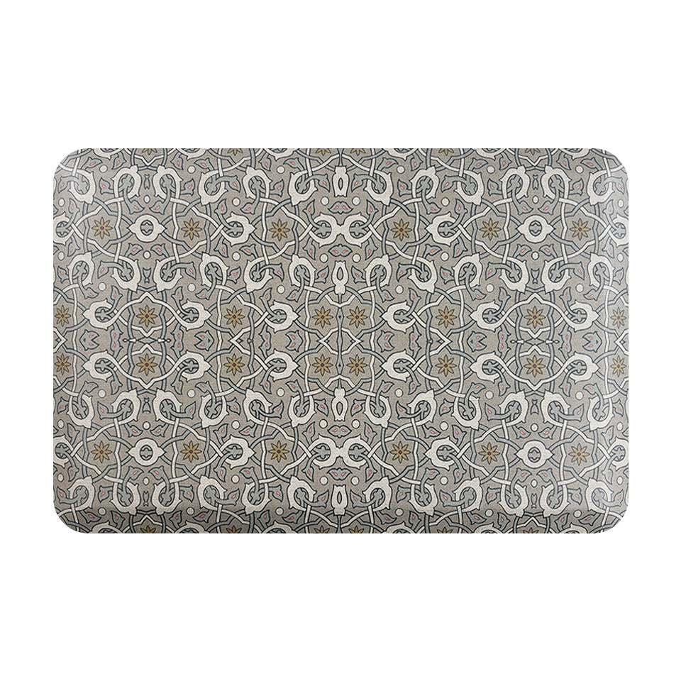 Happy Feet’s Ancient Arabesque anti-fatigue small mat has a blue and white symmetrical design on a grey background. 