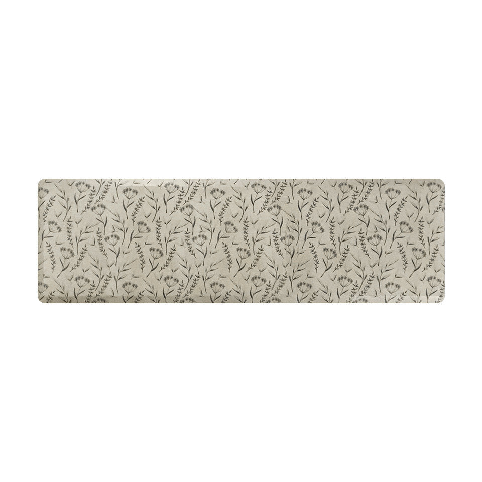 Comfortable foam anti-fatigue runner mat with beautiful black/brown botanical design on a beige background.