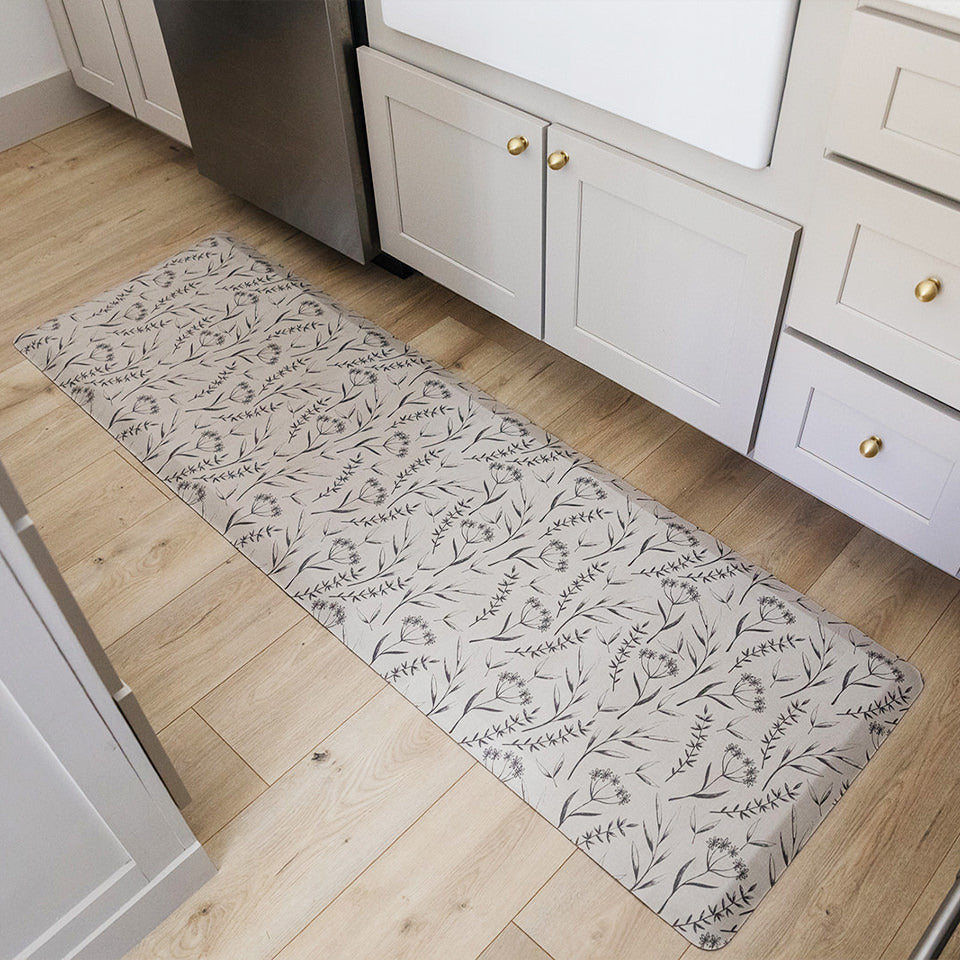 Happy Feet light brown Botanical runner mat in a kitchen in front of a sink and dishwasher.