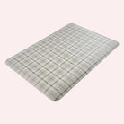 Happy Feet’s cream Brisbane Plaid anti-fatigue small mat at an angle showing for its beveled edges.