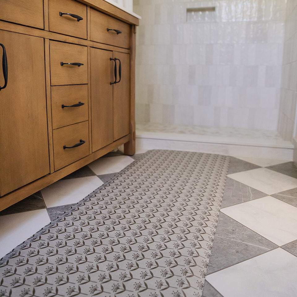 Happy Feet Dandelion Echo runner in a bathroom in front of a wooden vanity and open door shower