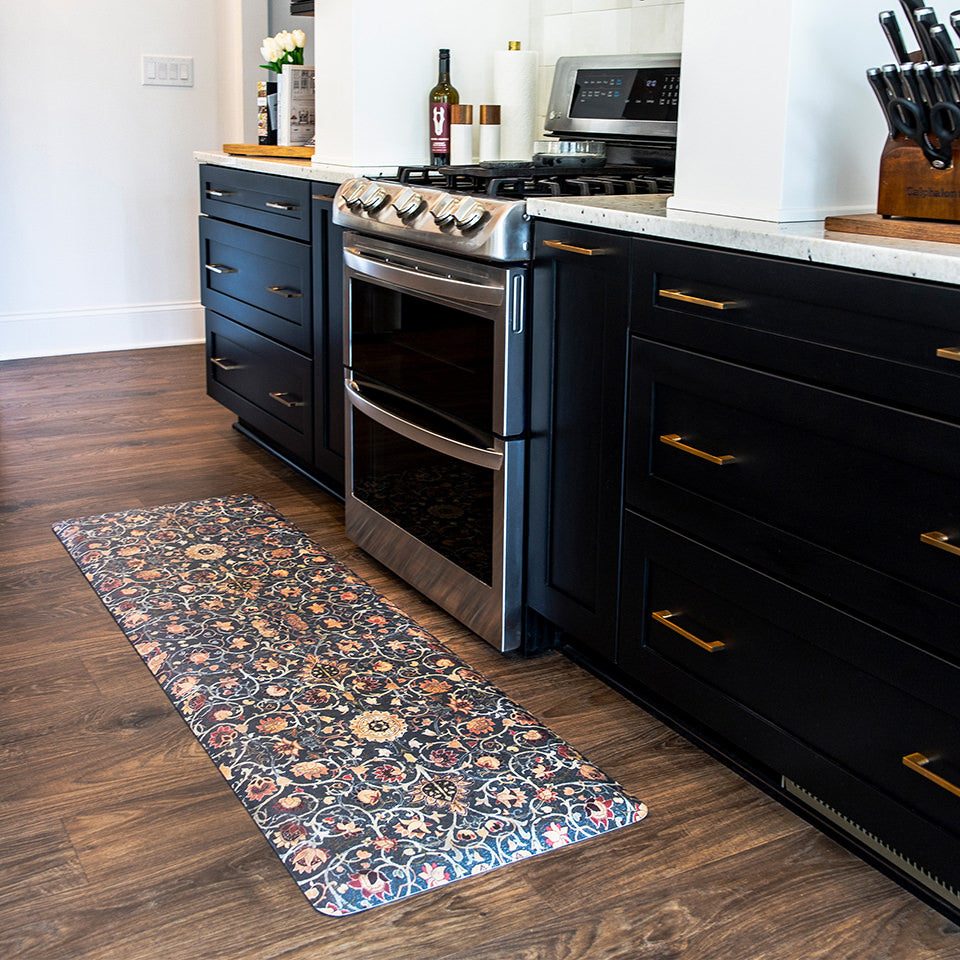 Ornate floral patten of muted warm tones on a deep navy background on a anti-fatigue Happy Feet runner in the kitchen.
