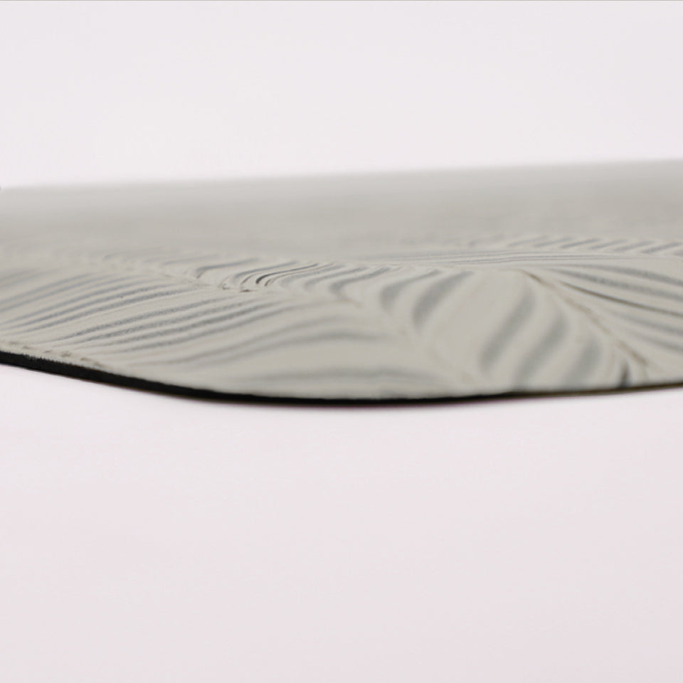 Up close corner image of the Featherbone anti-fatigue mat, showing the whimsical feather pattern and beveled edge.