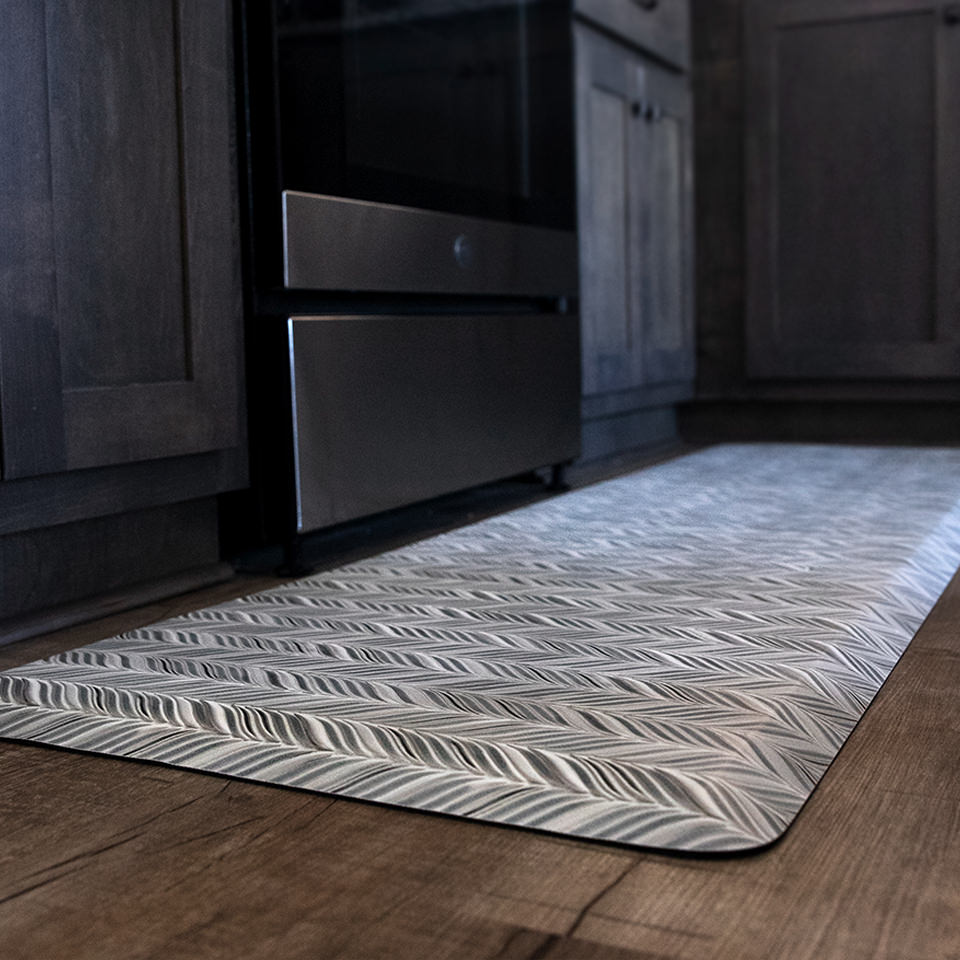 Beautiful Featherbone Happy Feet runner located in a kitchen; soft whites and greys contrast against the dark wood