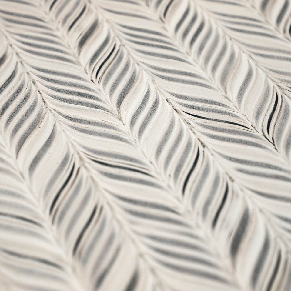 Detailed surface shot of featherbone's whimsical, feather design on a wipeable surface