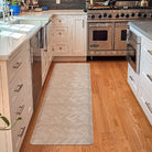 Herringbone runner mat in a kitchen for standing from and easy cleaning.