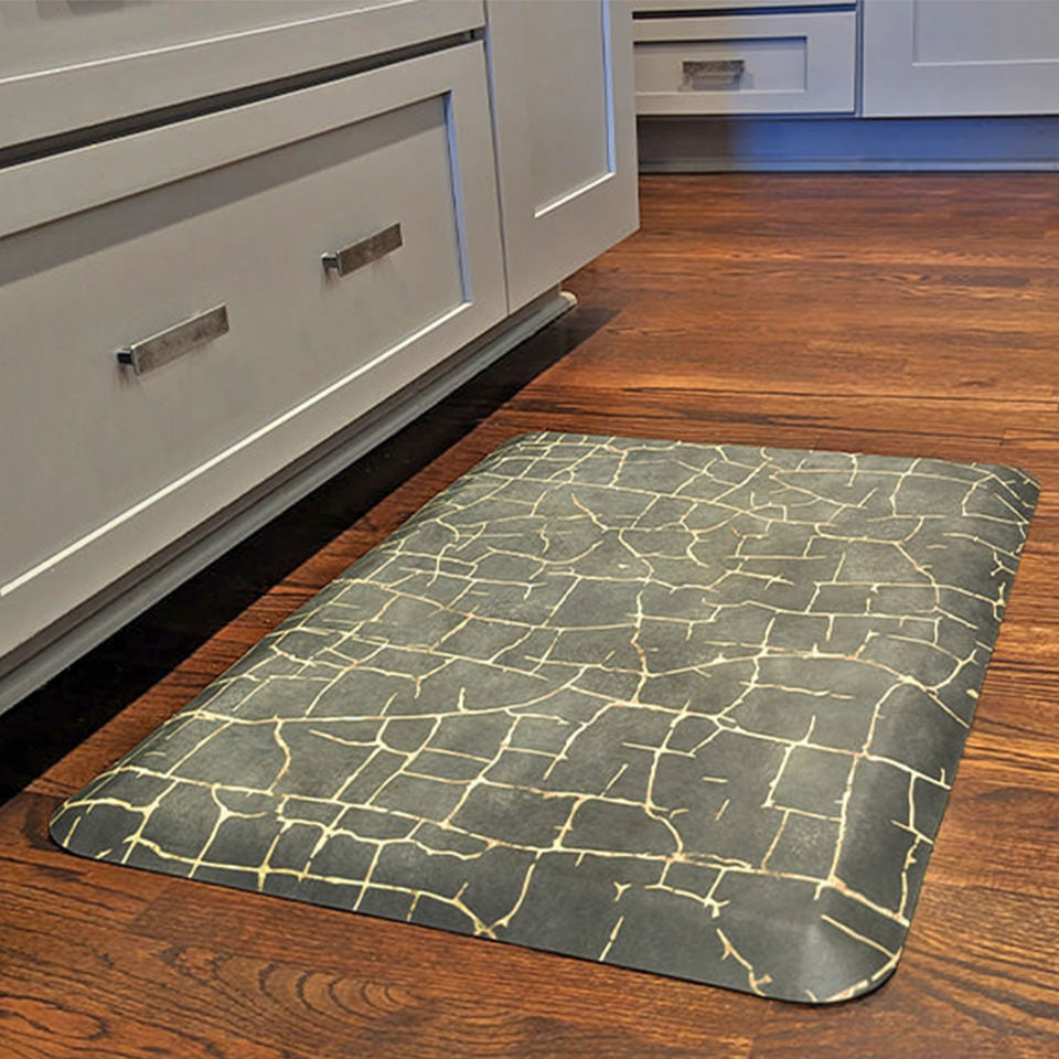 Anti-fatigue Kintsugi mat in front of a stove, comfortable on feet and wipeable surface.