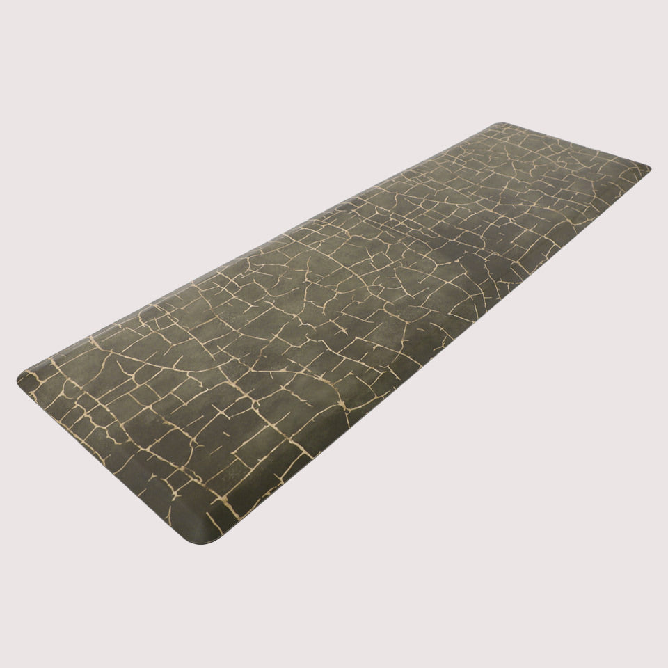 Angled image of anti-fatigue Kintsugi runner mat, surface of distressed greens and cracks of gold, wipeable and comfortable surface