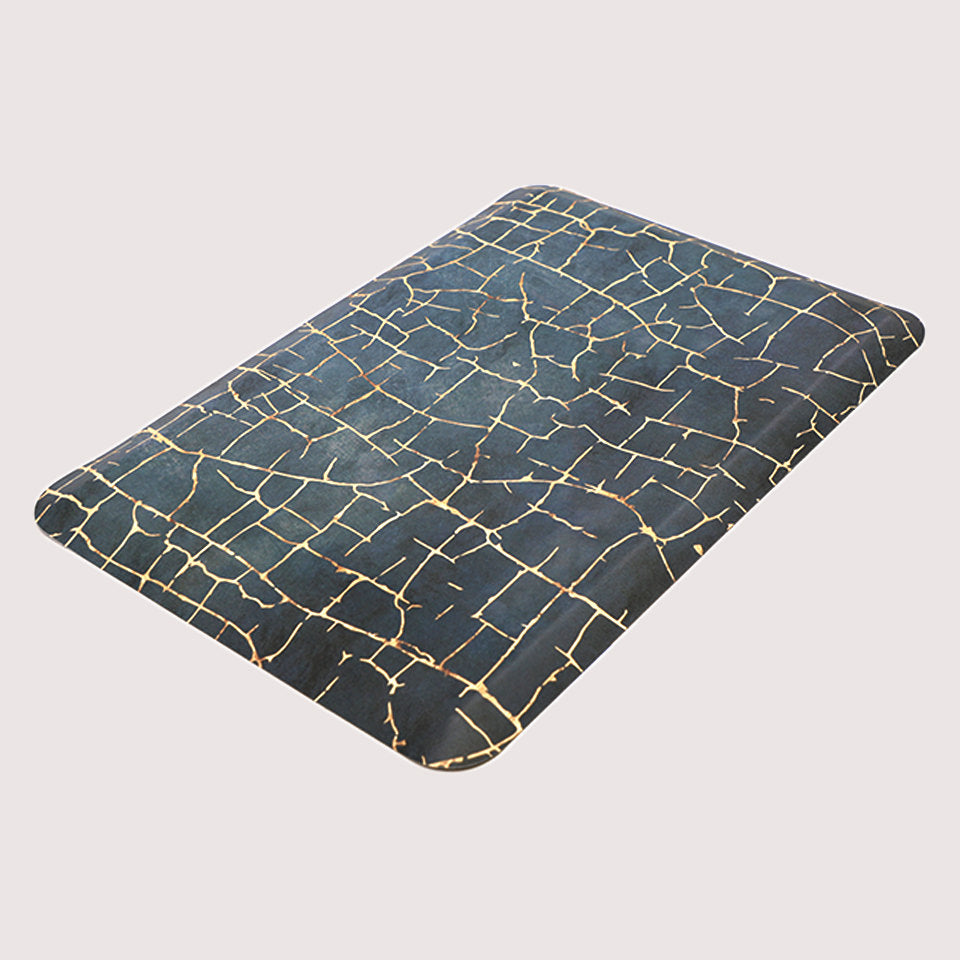 Angled image of anti-fatigue Kintsugi mat, surface of distressed blues and cracks of gold, wipeable and comfortable surface