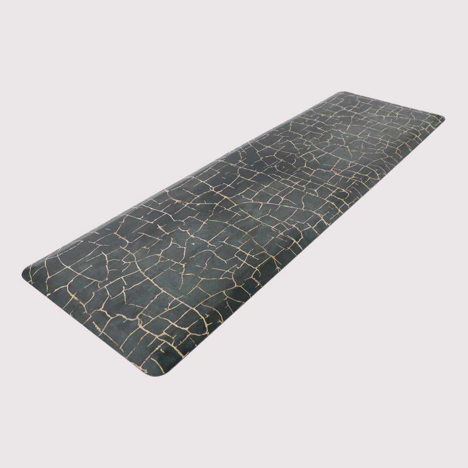 Angled image of anti-fatigue Kintsugi runner mat, surface of distressed blues and cracks of gold, wipeable and comfortable surface
