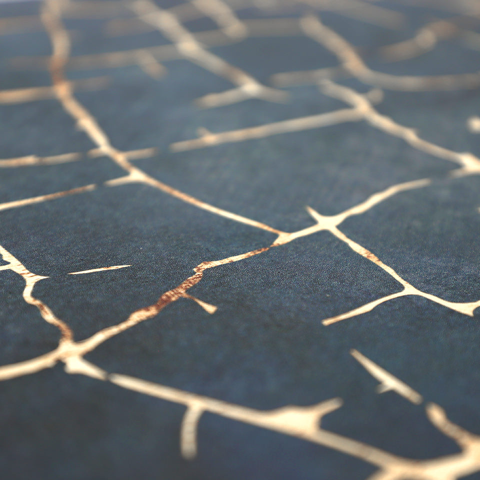 Detailed image of Kintsugi mat's surface of distressed blues and cracks of gold, wipeable surface