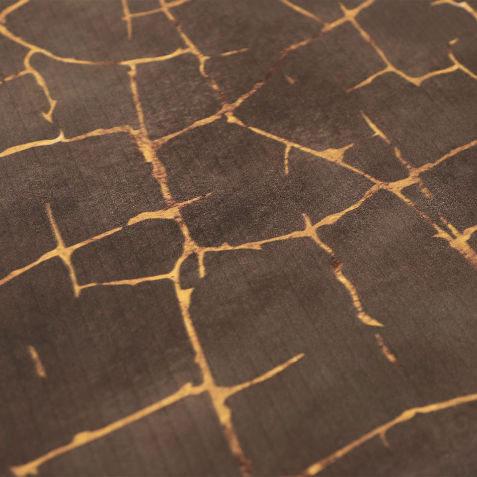Detailed image of Kintsugi mat's surface of distressed browns and cracks of gold, wipeable surface