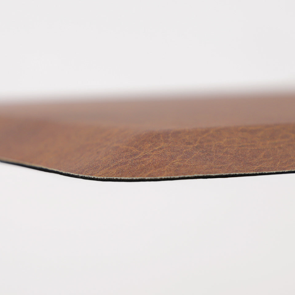 Detailed image of Happy Feet's anti-fatigue Leather mat in the color chestnut. The low profile shot highlights the 5/8" thick mat and the beveled edging on a white background.