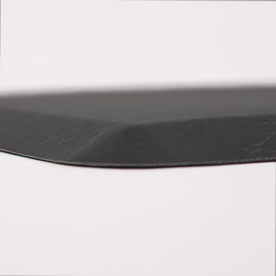 Detailed image of Happy Feet's anti-fatigue Leather mat in the color ebony. The low profile shot highlights the 5/8" thick mat and the beveled edging on a white background.