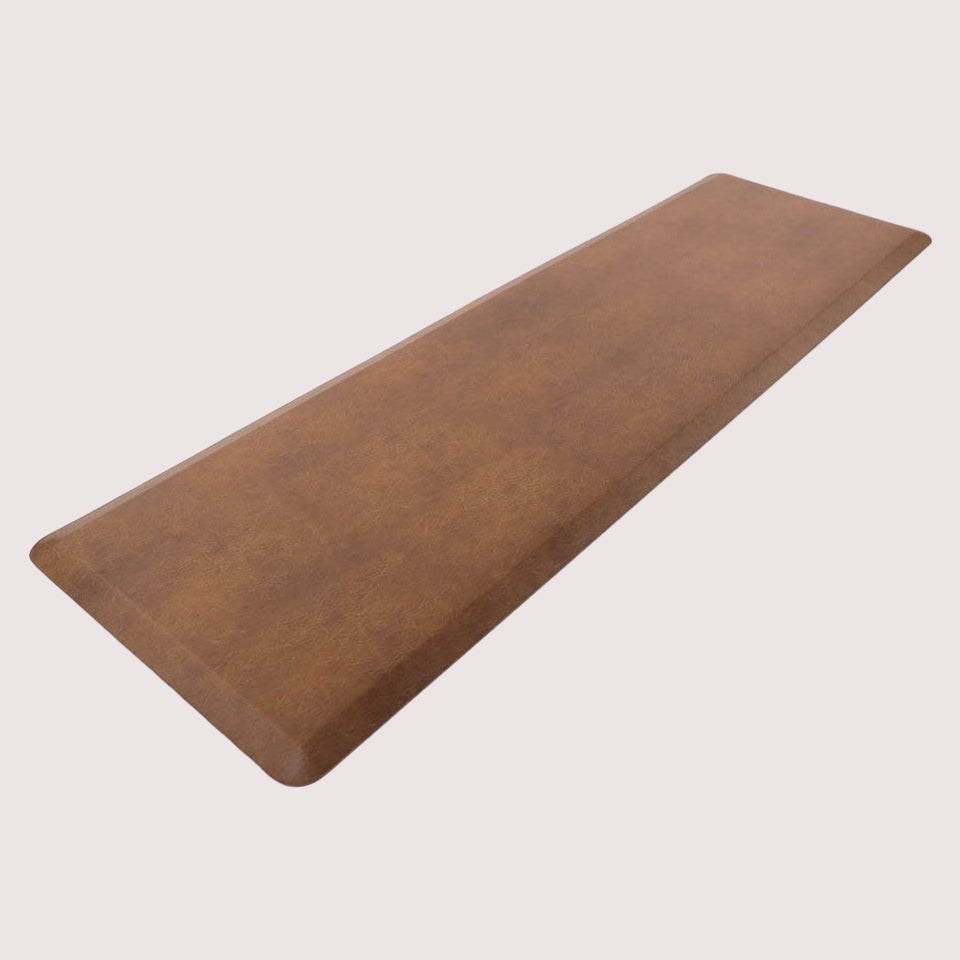 Angled image of the comfortable Leather anti-fatigue runner mat, with its waterproof, wipeable surface, and beveled edges