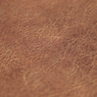 Detail image of Happy Feet's leather surface in chestnut with a water-resistant, wipeable surface