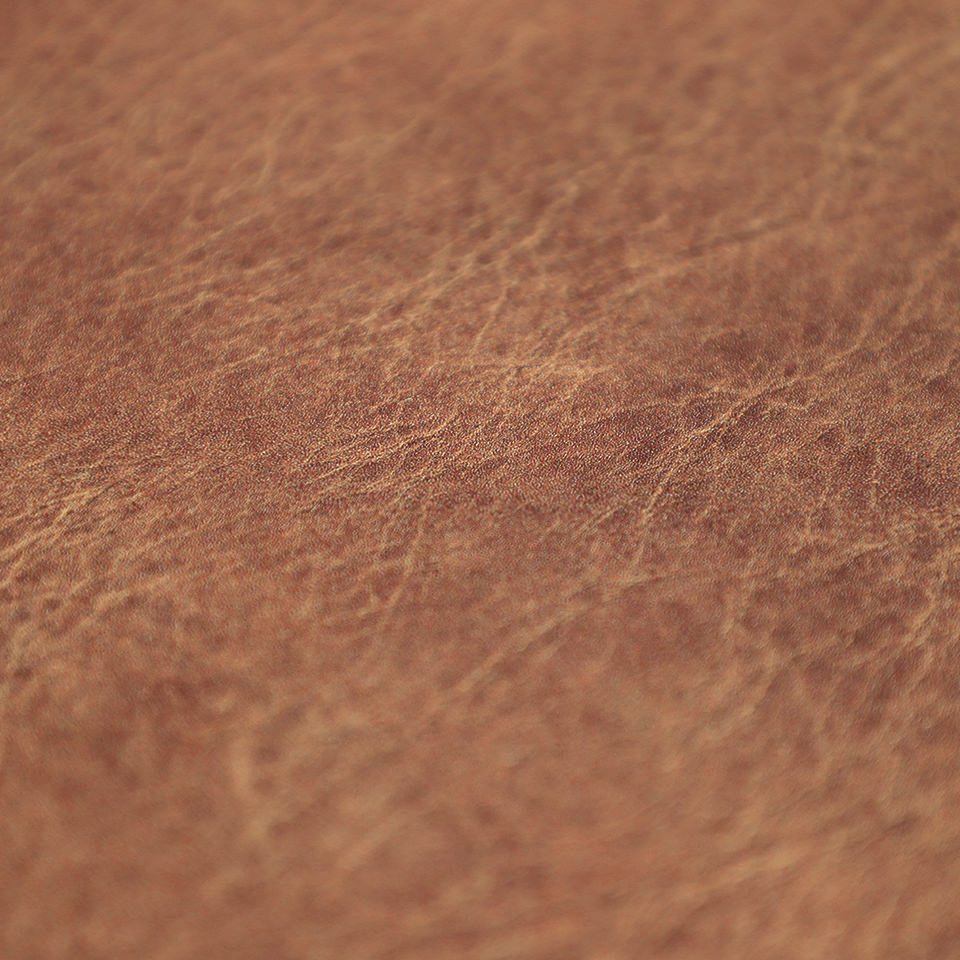 Detail image of Happy Feet's leather surface in chestnut with a water-resistant, wipeable surface