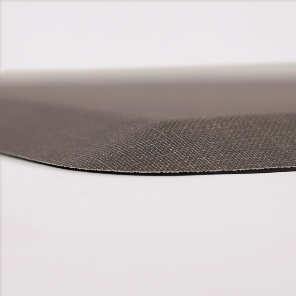 Detailed corner image of the anti-fatigue Happy Feet's Linen mat in a deep driftwood shade. The low profile shot highlights the 5/8" thick mat and the beveled edging on a white background.