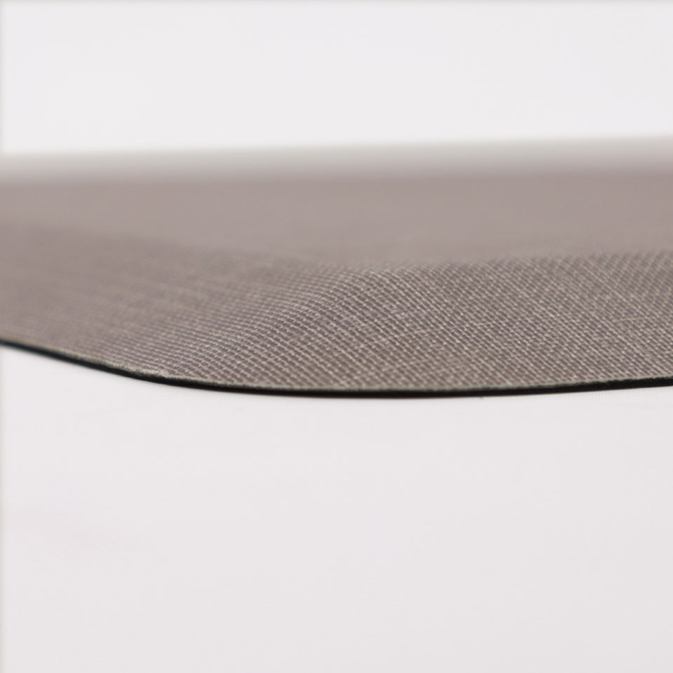 Detailed corner image of the anti-fatigue Happy Feet's Linen mat in a soft fog shade. The low profile shot highlights the 5/8" thick mat and the beveled edging on a white background.